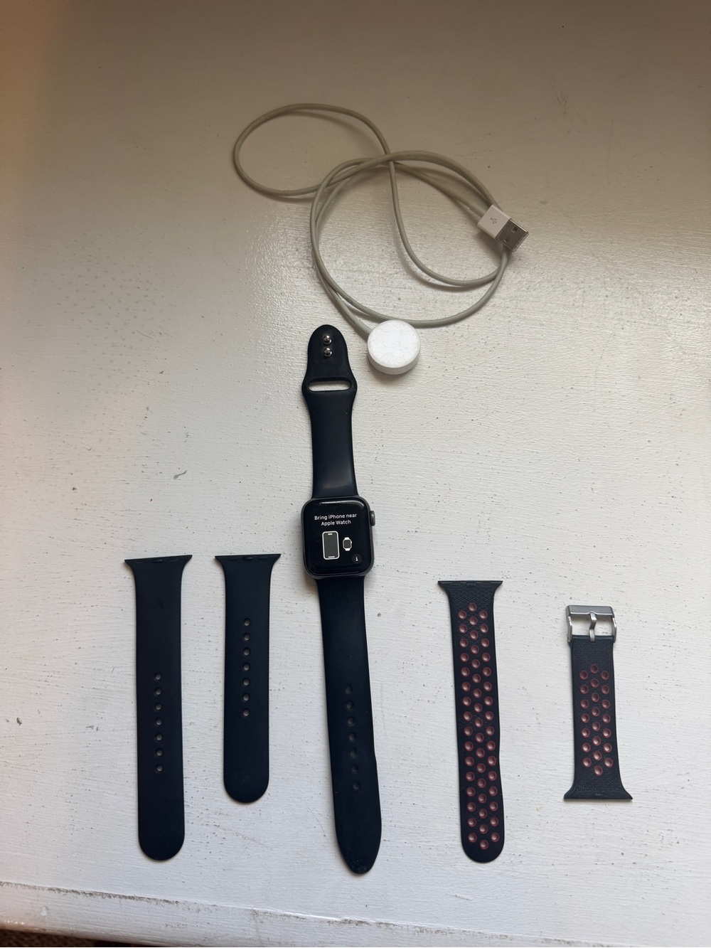Apple Black Smartwatch with Black and Black/Red Bands